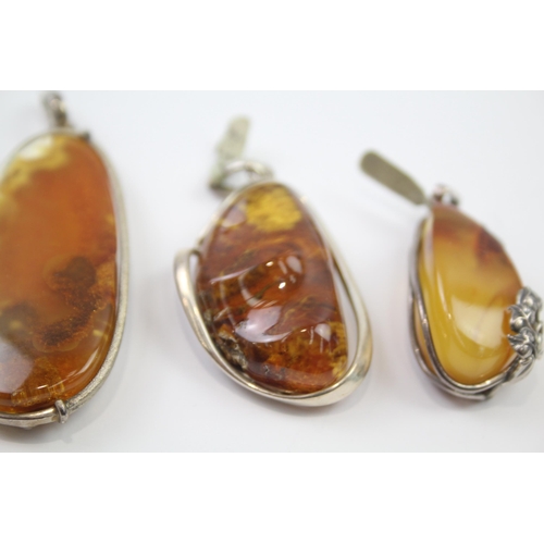 184 - Four silver Amber pendants including Baltic