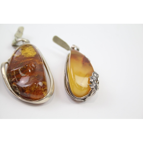 184 - Four silver Amber pendants including Baltic