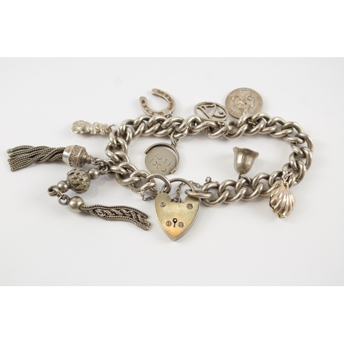 196 - Silver charm bracelet including antique watch chain tassels