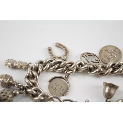 196 - Silver charm bracelet including antique watch chain tassels