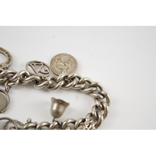 196 - Silver charm bracelet including antique watch chain tassels