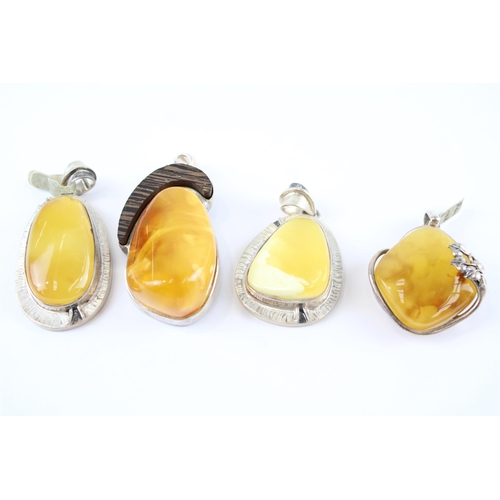 203 - Four silver Amber pendants including Butterscotch