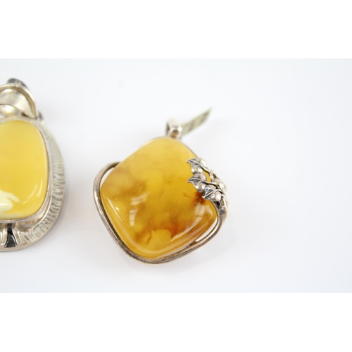 203 - Four silver Amber pendants including Butterscotch