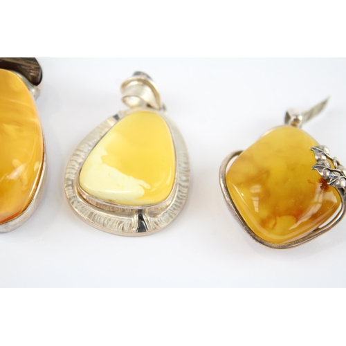 203 - Four silver Amber pendants including Butterscotch