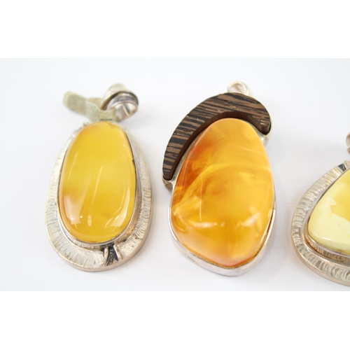 203 - Four silver Amber pendants including Butterscotch