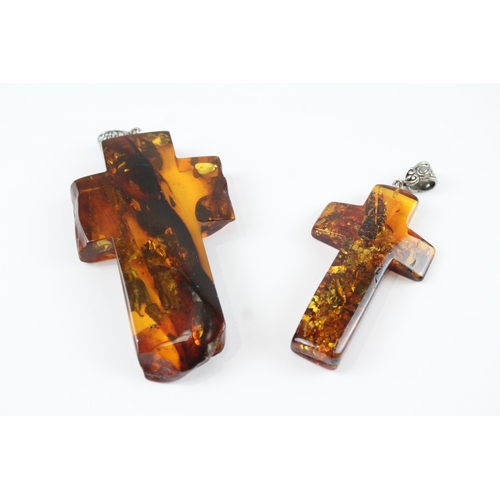 218 - Two Baltic Amber cross pendants