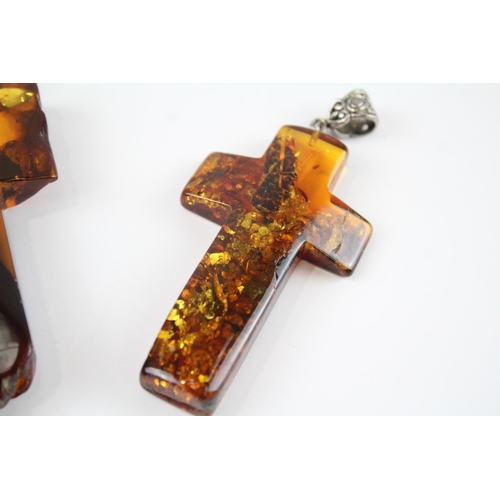 218 - Two Baltic Amber cross pendants