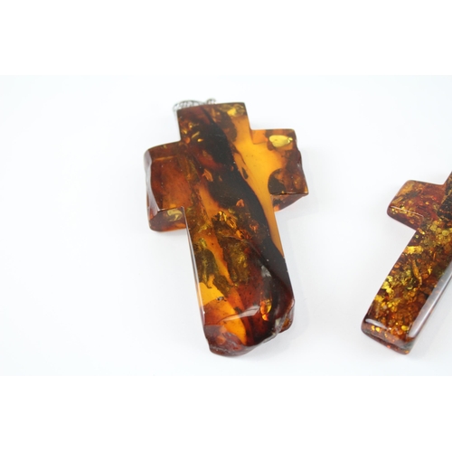 218 - Two Baltic Amber cross pendants