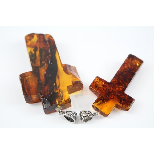 218 - Two Baltic Amber cross pendants