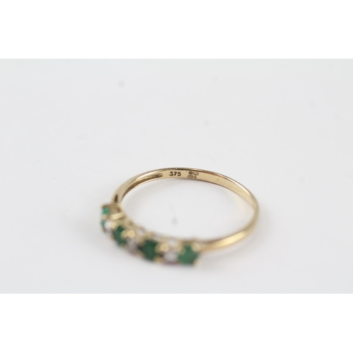 132 - 9ct gold emerald & diamond half eternity ring (1.1g) Size  P