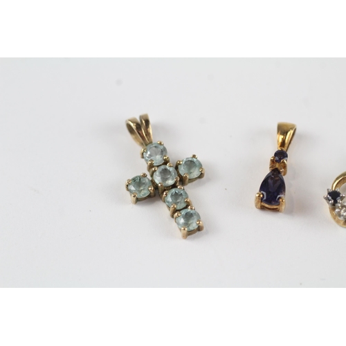 135 - 3x 9ct gold Iolite, sapphire, diamond & topaz pendants (2.8g)