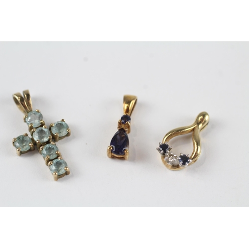 135 - 3x 9ct gold Iolite, sapphire, diamond & topaz pendants (2.8g)