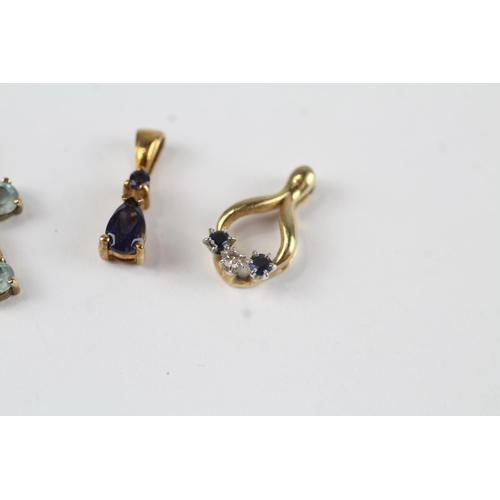 135 - 3x 9ct gold Iolite, sapphire, diamond & topaz pendants (2.8g)