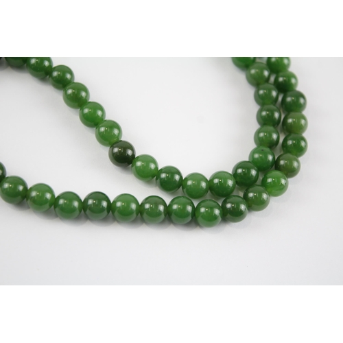 59 - 14ct gold clasp & bail nephrite single strand necklace with a carved pendant (84.1g)