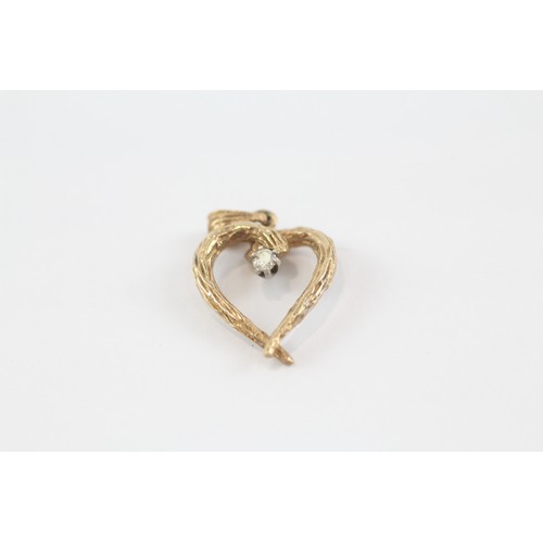 83 - 9ct gold 1970's diamond bark effect heart pendant (2.3g)