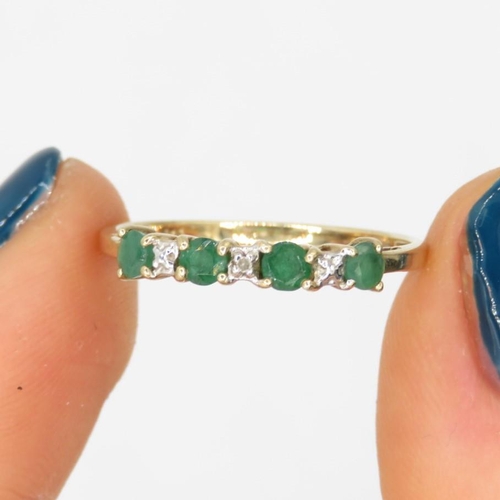 132 - 9ct gold emerald & diamond half eternity ring (1.1g) Size  P