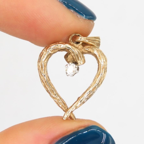 83 - 9ct gold 1970's diamond bark effect heart pendant (2.3g)