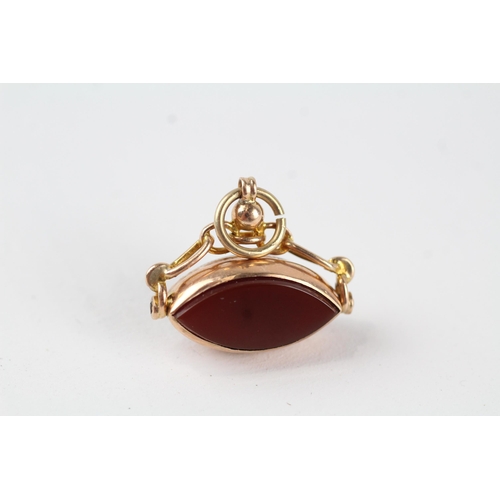 109 - 9ct gold vintage carnelian and onyx set marquise shaped spinning fob (3.3g)