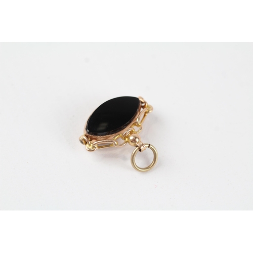 109 - 9ct gold vintage carnelian and onyx set marquise shaped spinning fob (3.3g)