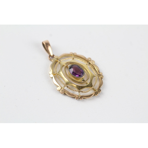 114 - 9ct gold purple paste openwork pendant (1.8g)