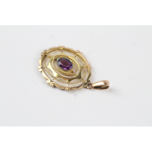 114 - 9ct gold purple paste openwork pendant (1.8g)