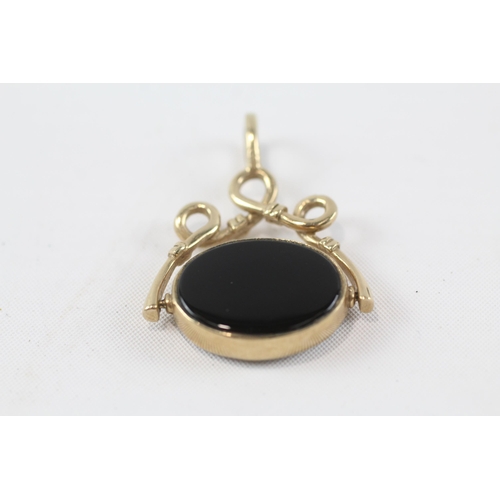 154 - 9ct gold onyx & mop swivel fob pendant (7.4g)