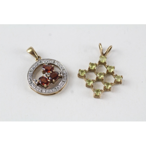 157 - 2 x 9ct gold garnet & white, yellow gemstone pendants (5.3g)