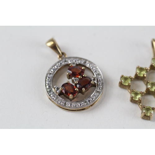 157 - 2 x 9ct gold garnet & white, yellow gemstone pendants (5.3g)