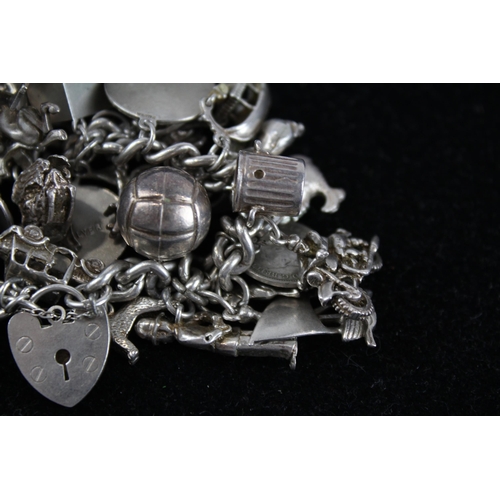 176 - Silver charm bracelet including emergency money charm (110g)