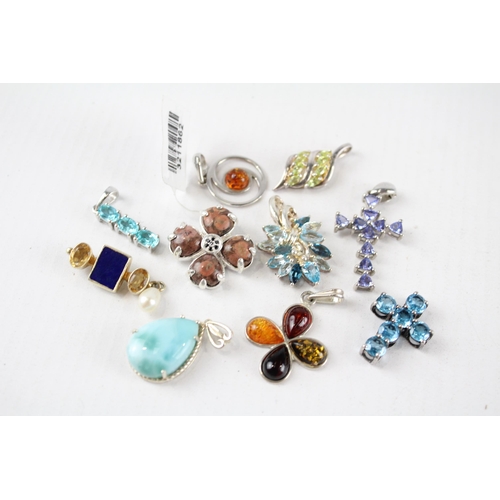 187 - A collection of silver gemstone pendants including Amber (26g)