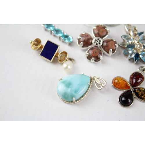 187 - A collection of silver gemstone pendants including Amber (26g)