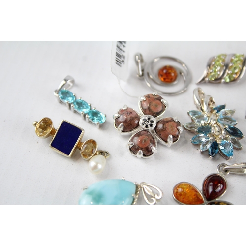 187 - A collection of silver gemstone pendants including Amber (26g)