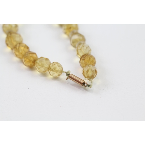 51 - 9ct gold clasp hand faceted citrine & rock crystal graduated single strand necklace (42.6g)