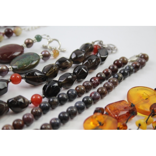 181 - A collection of silver clasped gemstone necklaces including amber (329g)