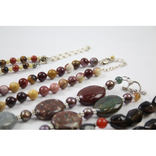 181 - A collection of silver clasped gemstone necklaces including amber (329g)