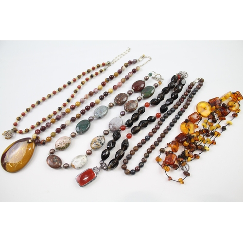 181 - A collection of silver clasped gemstone necklaces including amber (329g)