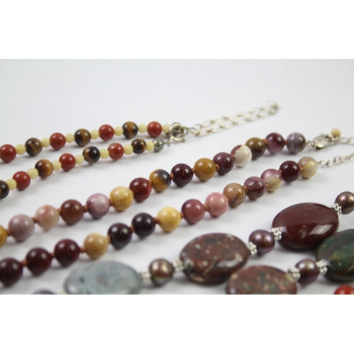 181 - A collection of silver clasped gemstone necklaces including amber (329g)