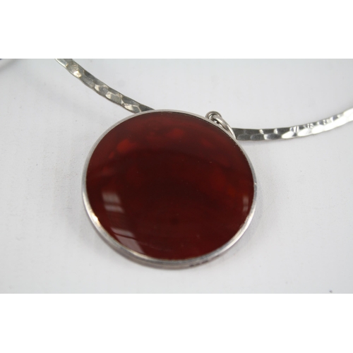 205 - Two sterling silver pendant torque necklaces including carnelian (60g)