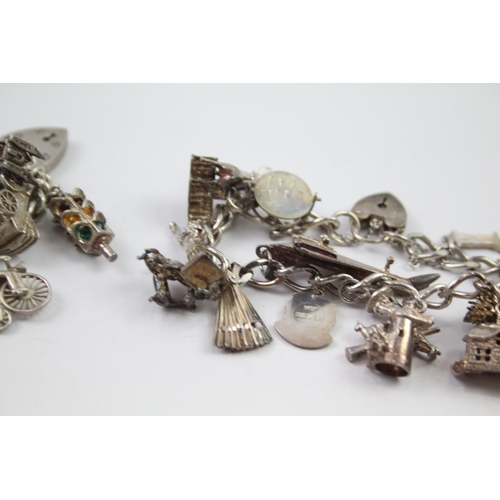 209 - Vintage sterling silver charm bracelet packed with charms (109g)