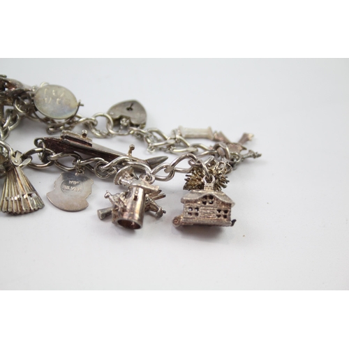 209 - Vintage sterling silver charm bracelet packed with charms (109g)