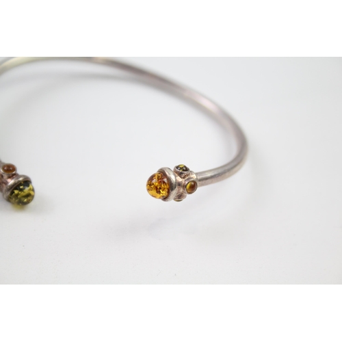 221 - Two sterling silver amber bangle bracelets (25g)