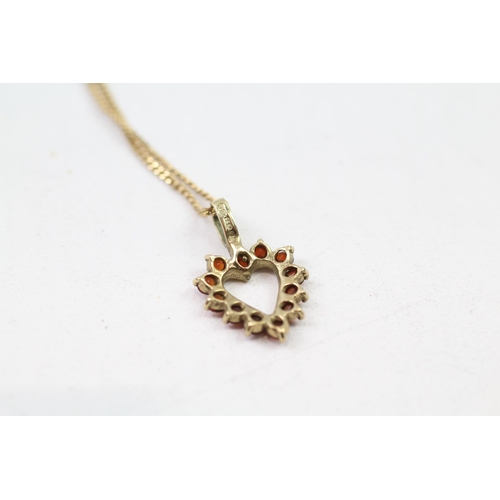 83 - 9ct gold garnet heart pendant & chain (2.9g)