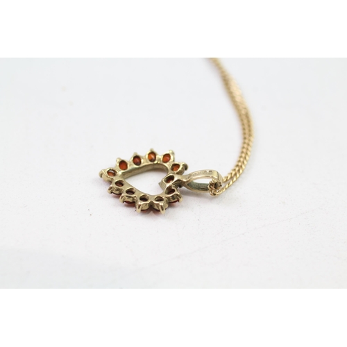 83 - 9ct gold garnet heart pendant & chain (2.9g)