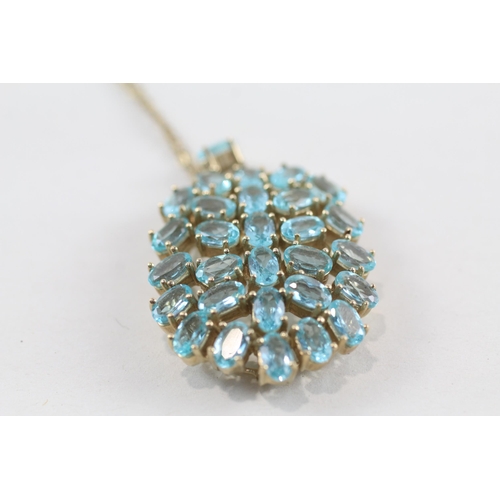 197 - 9ct gold blue topaz pendant & chain (8.5g)