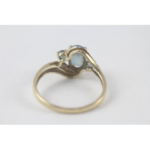 198 - 9ct gold blue topaz & diamond ring (2.3g) Size  R