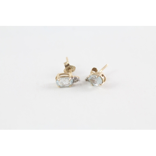 58 - 2 x 9ct gold diamond & topaz stud earrings (1.7g)