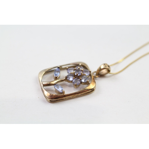 69 - 9ct gold blue tanzanite floral pendant & chain (2g)