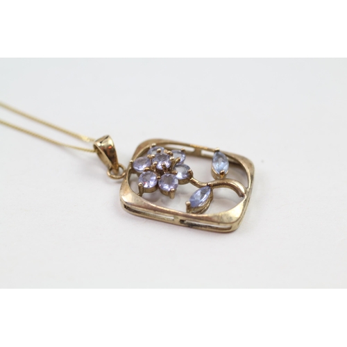 69 - 9ct gold blue tanzanite floral pendant & chain (2g)