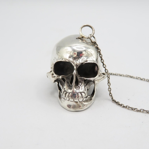 Extremely fine detailed articulated Momento Mori human skull in sterling silver with hinged bottom jaw and locking pin.  Skull has hanging safety chain to wear as fob or pendant  (33.3g) 40mm long.  In excellent condition