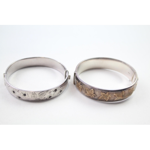 172 - Two silver bangles with gold accents and gemstone (61g)